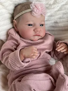 Close-up of Levi reborn doll featuring realistic skin texture and pink lace headband