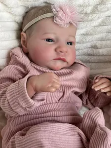 Macro shot of 49cm reborn baby doll with realistic hand-painted hair and pink lace headband
