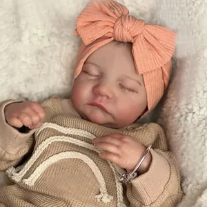 Realistic 19 inch reborn Levi sleeping baby doll in waffle knit top and pink headband