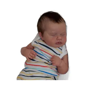 Realistic sleeping reborn baby doll with brown hair in colorful striped romper