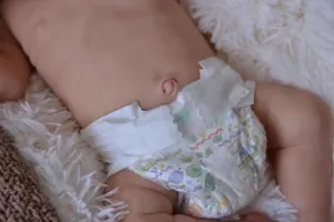 Detailed view of the realistic newborn doll's skin texture and printed baby diaper
