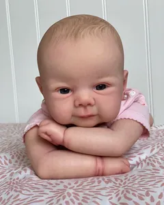 Close-up of a realistic 19-inch Reborn Juliette doll with detailed skin and pink floral outfit
