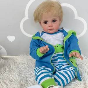 Realistic 60cm Reborn Toddler Maddie doll in blue frog hoodie on plush white carpet
