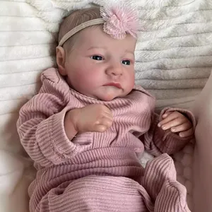 Realistic 49cm reborn baby Levi doll in pink ribbed romper with floral headband