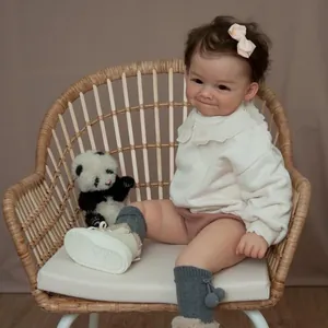 Close-up of 60cm reborn doll with realistic dimples, hand-rooted hair and panda plush toy