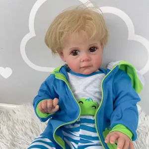 60cm Reborn Toddler Maddie doll with blonde hair and colorful hooded jacket on white plush rug