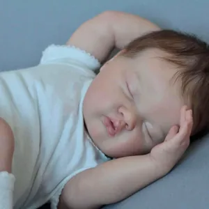 Lifelike 19-inch sleeping reborn baby doll Ashia with brown hair and lace outfit