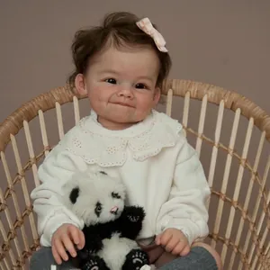 Lifelike 60cm reborn baby doll with dimples and panda plush toy in a woven chair