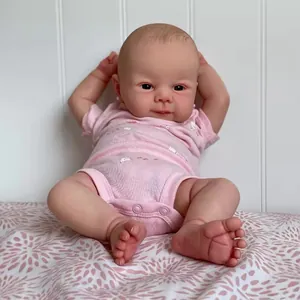 Realistic 19 inch Juliette reborn baby doll wearing a pink floral short sleeve romper