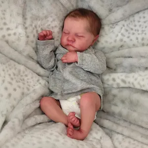 Lifelike 19-inch Levi Reborn Doll sleeping in a grey outfit on a soft leopard print blanket