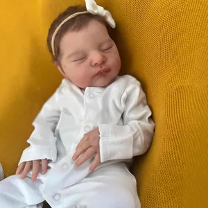 Realistic 19-inch newborn reborn baby doll sleeping in white onesie on yellow blanket