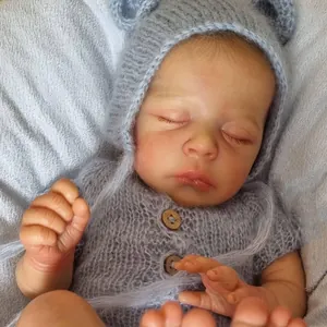 Realistic 18-inch Jude reborn baby doll wearing grey knit mohair outfit and hat