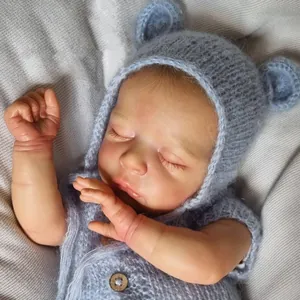 Lifelike 18-inch reborn baby doll Jude sleeping in blue knit outfit with bear ear hat
