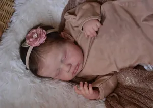 Close-up of 19-inch lifelike reborn doll Loulou with soft skin and floral headband