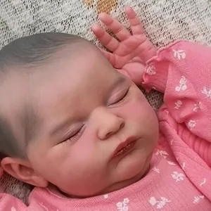 Lifelike 20-inch reborn baby doll Laura with 3D skin and pink floral outfit in a sleeping pose