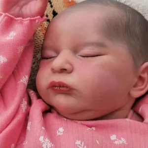 Realistic 20 inch reborn baby doll Laura with 3D skin and visible veins in pink knitwear