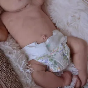 Realistic 19 inch Loulou reborn baby doll with lifelike skin details and cartoon diaper