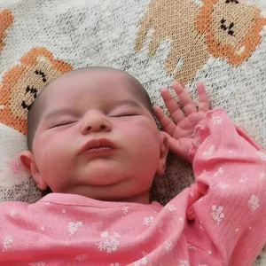Realistic 20-inch newborn reborn baby doll Laura with detailed skin texture in floral romper