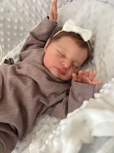 Macro detail of 20-inch reborn baby doll Laura showing realistic 3D skin and knitwear