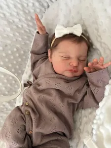 Close-up of mauve hollow knit long-sleeved baby romper and white bow headband