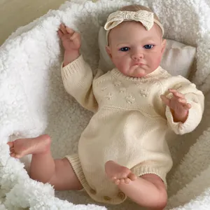20 inch lifelike reborn baby doll in knit romper with 3D skin texture on plush cradle