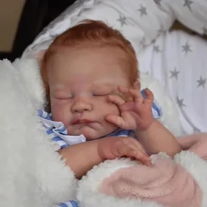 Realistic 19 inch reborn sleeping baby doll with reddish brown hair and striped outfit