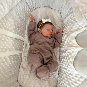 20-inch lifelike Reborn Baby Laura doll in pink knit romper with white bow headband