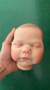 Macro detail of 19 inch reborn doll head with realistic painted skin and hair texture