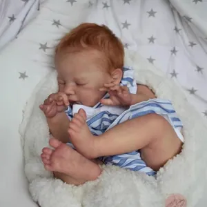 Lifelike 19-inch reborn baby doll August sleeping in blue striped shirt on star blanket