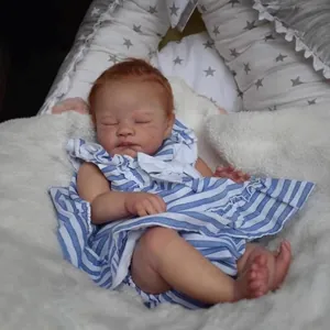 Realistic 19-inch reborn baby doll sleeping in blue striped dress on soft plush blanket