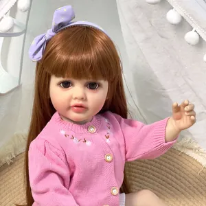 Poupée Reborn Betty réaliste 55cm, cheveux bruns, gilet rose et bandeau étoilé