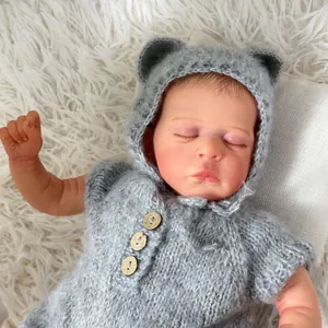 Realistic 49cm sleeping reborn doll wearing grey knitted romper with bear hood