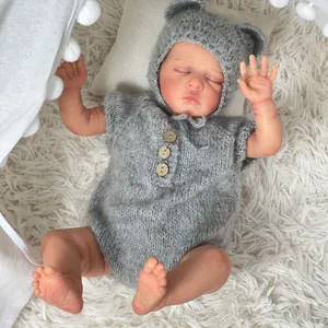 Lifelike 49cm reborn baby doll in grey knit romper with ears hat on plush rug