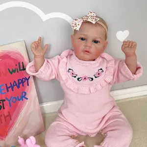50cm realistic reborn baby doll with hand-painted hair in a pink knit romper