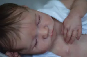 Close-up of realistic skin texture and implanted hair on a sleeping Levi reborn doll