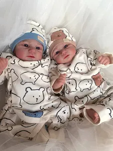 Detailed top view of two realistic Elijah reborn baby dolls in bear print onesies