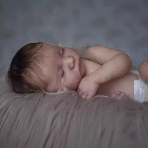 Realistic 49cm reborn baby Levi doll with rooted hair sleeping in a soft plush blanket