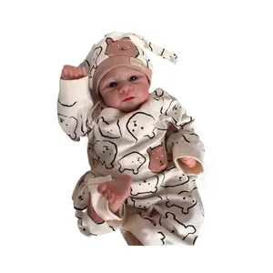 Lifelike 49cm Elijah reborn baby doll wearing a cute cartoon bear romper and hat