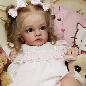 Lifelike reborn baby doll with curly hair and pink lace dress including plush teddy accessories