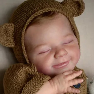 Realistic 49cm reborn baby doll wearing a brown knit bear ear hat and matching cardigan
