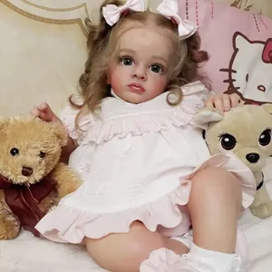 Realistic reborn baby doll with curly hair in a pink princess dress sitting at home