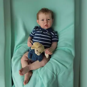 Realistic Liam reborn baby boy doll with 3D skin and blue striped polo shirt