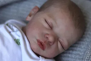 Macro shot of realistic facial details and eyelashes on a 48cm reborn baby doll