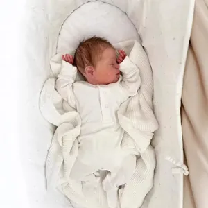 Realistic 49cm newborn baby doll Demi sleeping in white bodysuit and knitted blanket