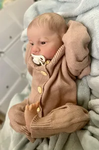 Close-up of 49cm reborn baby doll Levi with lifelike 3D skin and knit outfit