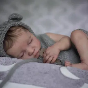 Lifelike 19-inch reborn baby doll sleeping in gray knit outfit and bear ear hat