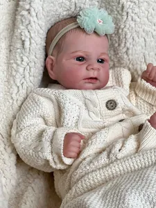 Realistic 46cm Elijah reborn baby doll with blue eyes and cream knit cardigan