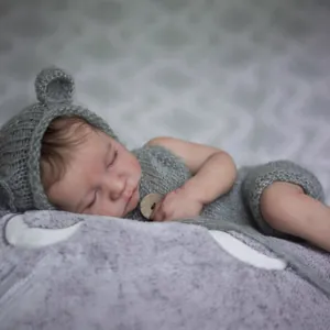 Lifelike 19 inch Reborn Baby Levi doll in grey knit outfit with cozy sleeping pose
