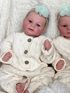 Detailed close-up of 46cm lifelike reborn baby doll in knit outfit with flower headband