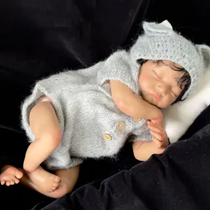 Realistic 19 inch Levi reborn baby doll with brown skin in a grey knit bear romper